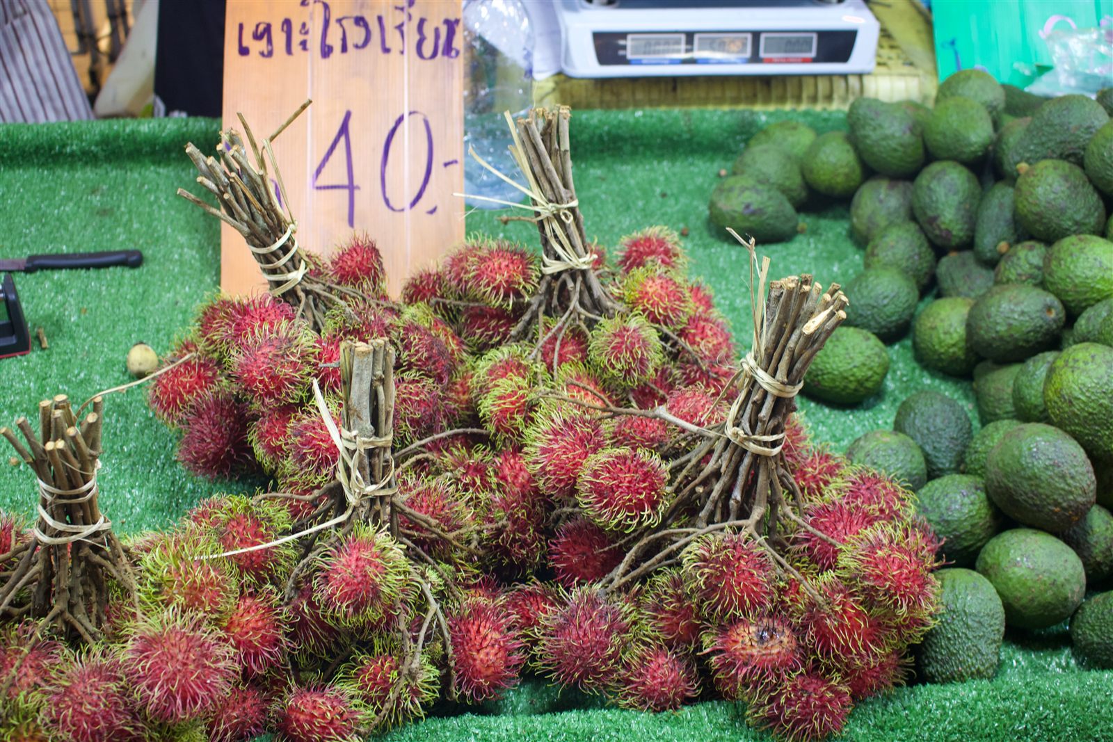 Street Food & Tuk-Tuk — bundles of fresh rambutan at a fruit stall